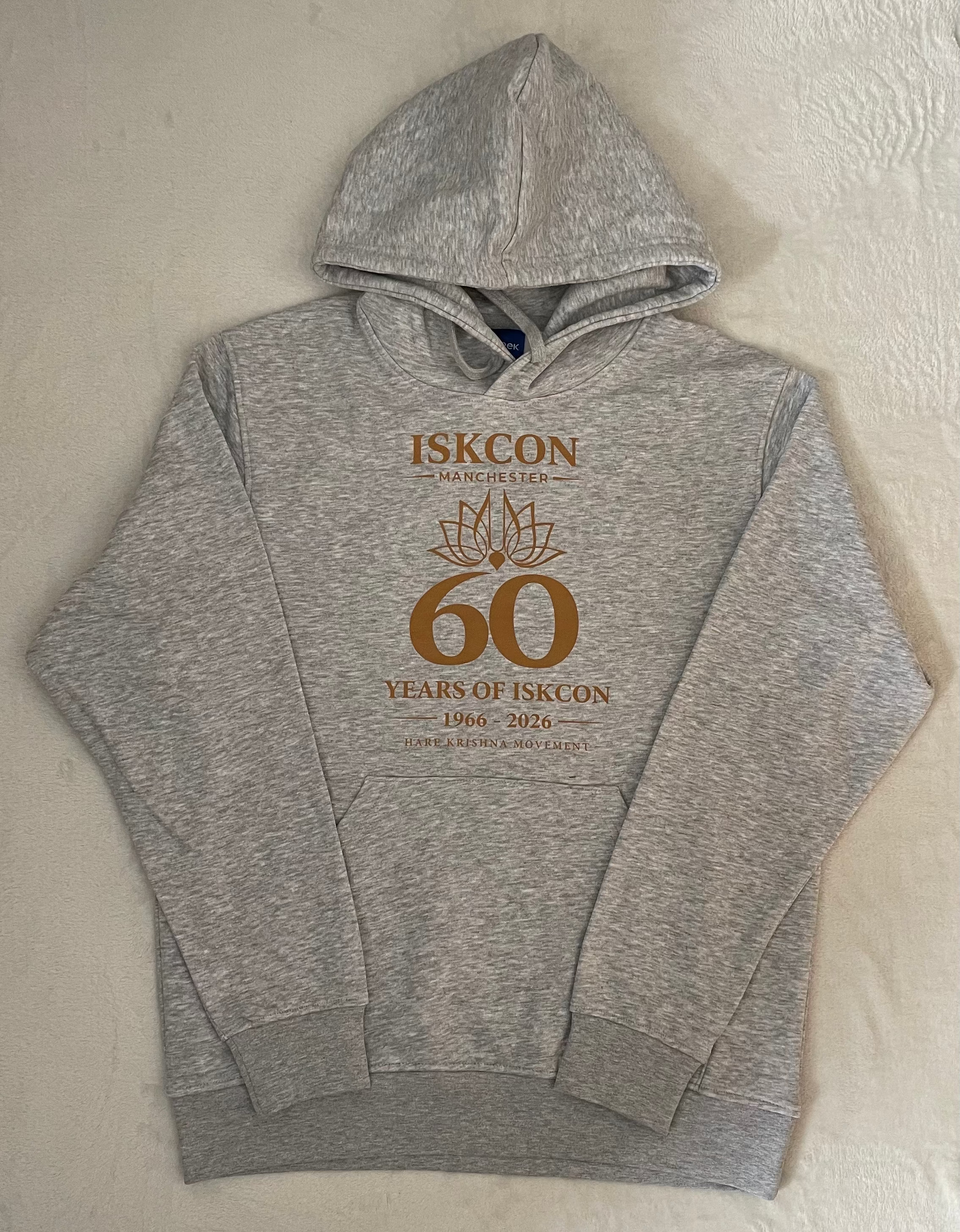 Gray hoodie with 'ISKCON 60 Years' text on a beige surface