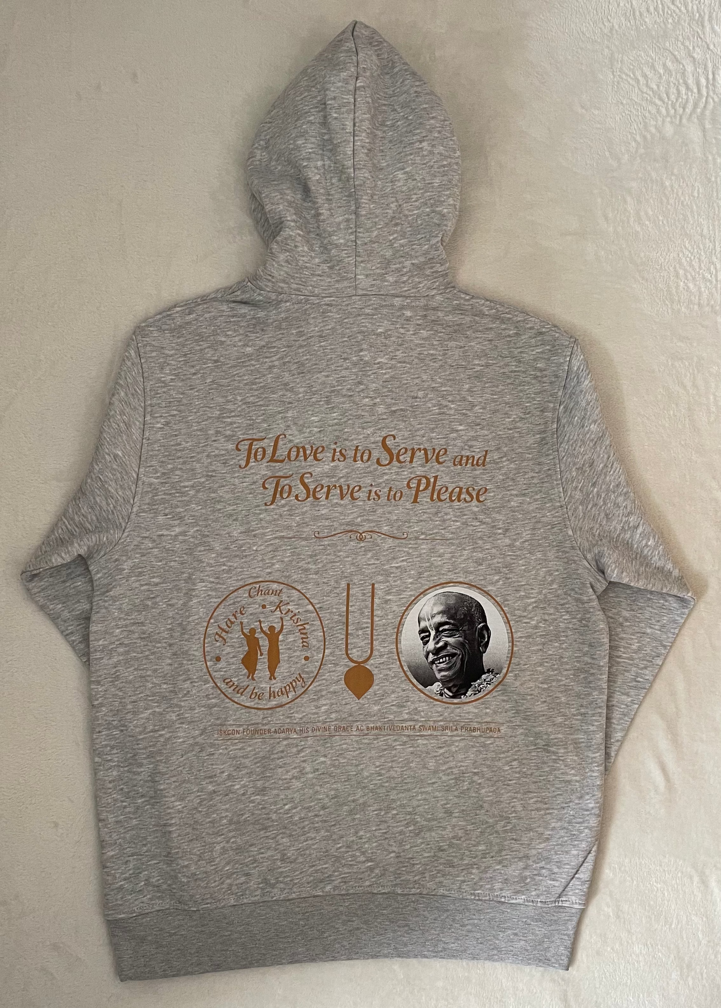 Gray hoodie with printed design on a light beige background