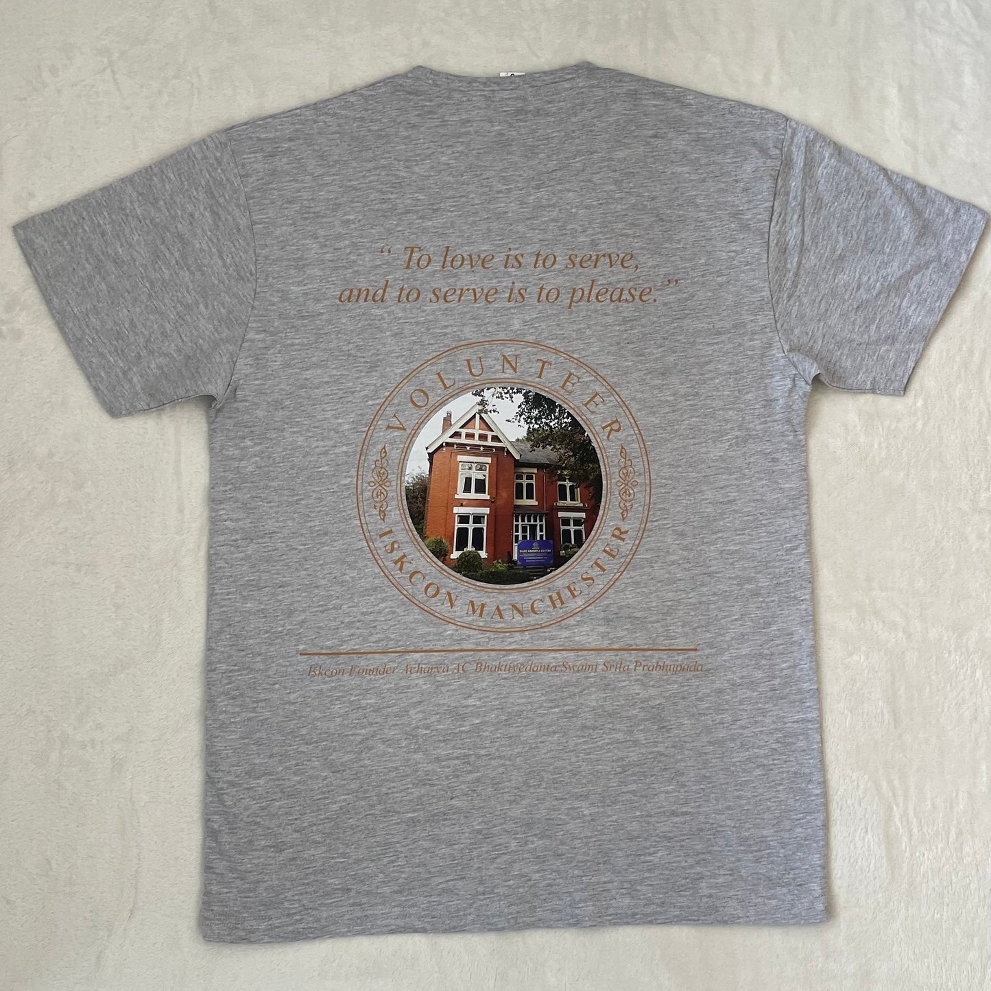 Gray t-shirt with printed design and text on a light gray background